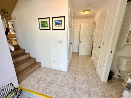 a hallway of a home with a staircase and a toilet at Bluewater Haven in Jensen Beach