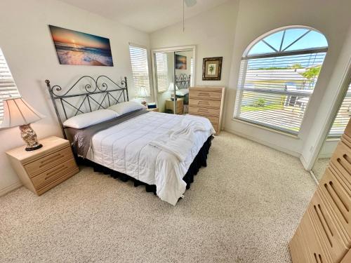a bedroom with a bed and a large window at Bluewater Haven in Jensen Beach
