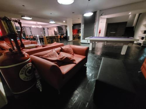 a living room with a couch and a table at Santa Rosa Hotel in Olavarría