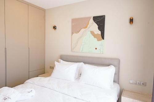 a bedroom with a white bed with white pillows at Casa Olea Apart Hotel in Çeşme
