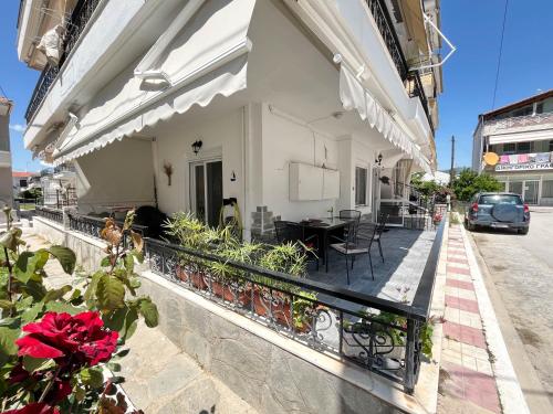 a balcony of a building with a table and chairs at Veranda Apartment Paralia Ofriniou in Ofrínion