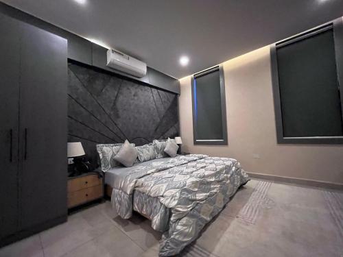 a bedroom with a large bed with a large headboard at Ridge Apartments in Kano