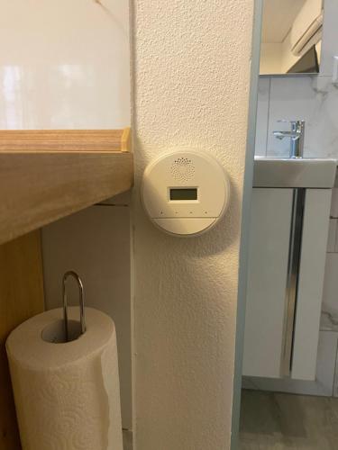 a roll of toilet paper sitting next to a sink at Gemütliches Apartment in Baden-Baden