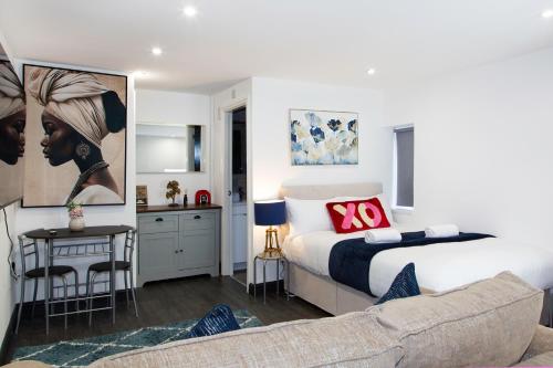 a bedroom with a bed and a living room at Snuggle Cove Apartments- Walton Road in Liverpool