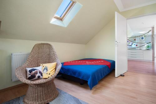 a bedroom with a bed and a wicker chair at Julenhof in Loitz