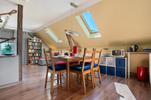 a kitchen with a table and chairs in a room at Julenhof in Loitz