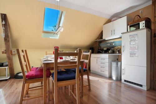 a kitchen with a table and chairs in a room at Julenhof in Loitz
