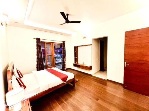 a bedroom with a bed and a ceiling fan at HILLS CROWN Key Shree Bhawan in Bhowāli