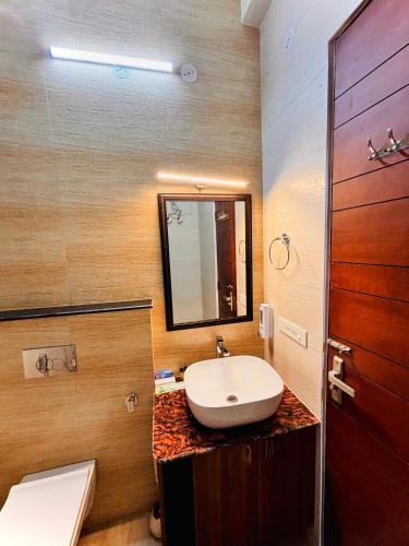 a bathroom with a sink and a mirror at HILLS CROWN Key Shree Bhawan in Bhowāli