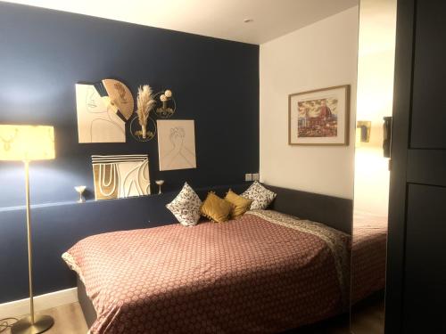 a bedroom with two beds and a blue wall at Double bed Studio in Finchley,North London in Finchley