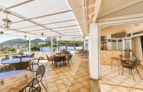 an outdoor dining area with tables and chairs and a patio at Hotel Villa D'Orta in Ischia