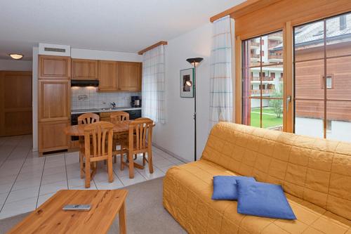 a living room with a couch and a table at Les Naturelles in Leukerbad