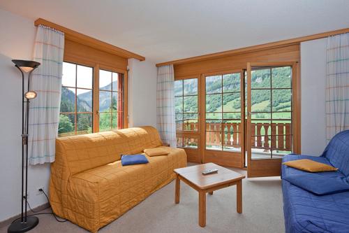a living room with a couch and a table at Les Naturelles in Leukerbad