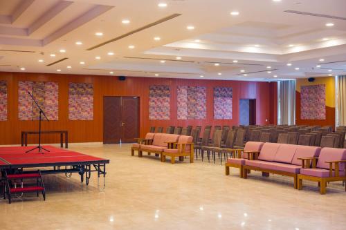 a room with chairs and tables and ping pong tables at Eternal Oasis by Alaya Stays, Golf Course Road in Gurgaon