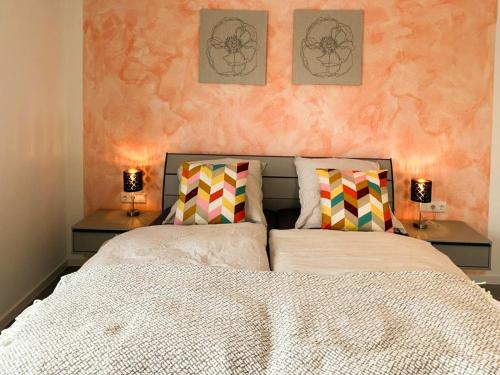 a bedroom with a large bed with two night stands at Hotel und Ferienwohnungen Nebauer in Frontenhausen