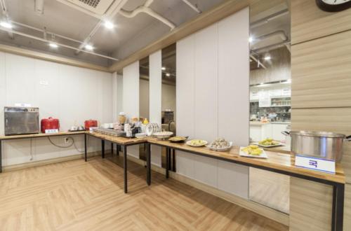 a kitchen with a long counter in a room at Gwangju Hanam 1st Hotel in Gwangju