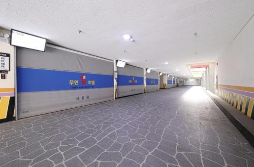 a hallway of a building with a train on the wall at Gwangju Hanam 1st Hotel in Gwangju