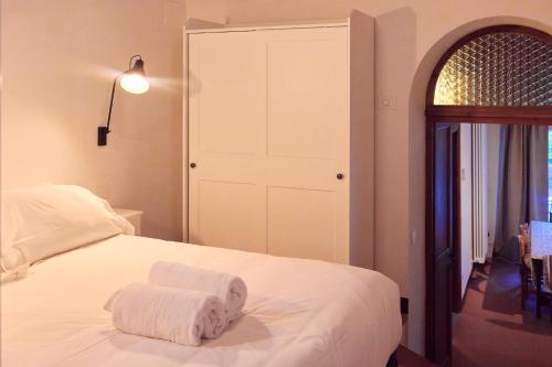 a bedroom with a bed with two towels on it at Agriturismo Fattoria Poggio di Fiesole in Fiesole