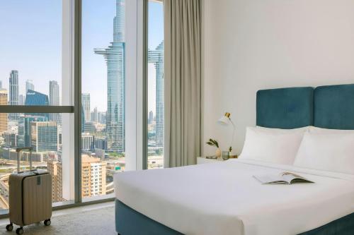 a hotel room with a bed and a large window at Sonder by Marriott Bonvoy Downtown Towers Apartments in Dubai