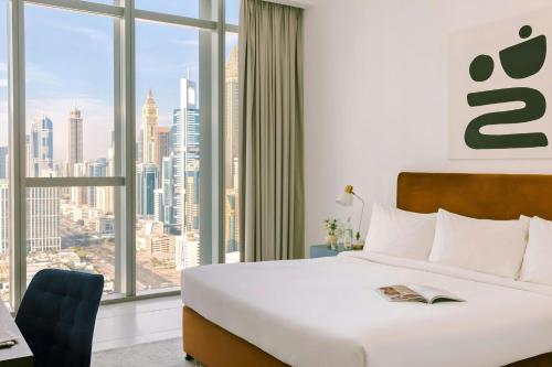 a hotel room with a bed and a large window at Sonder by Marriott Bonvoy Downtown Towers Apartments in Dubai