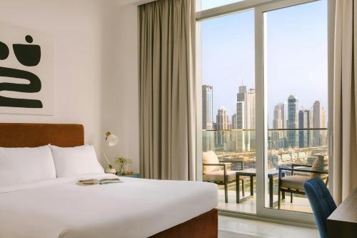 a hotel room with a bed and a large window at Sonder by Marriott Bonvoy Downtown Towers Apartments in Dubai