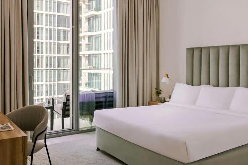 a hotel room with a bed and a large window at Sonder by Marriott Bonvoy Downtown Towers Apartments in Dubai