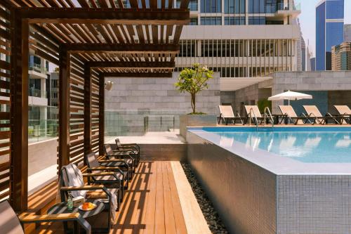 a swimming pool on a building with chairs at Sonder by Marriott Bonvoy Downtown Towers Apartments in Dubai
