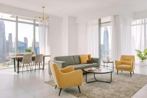 a living room with a couch and chairs and a table at Sonder by Marriott Bonvoy Downtown Towers Apartments in Dubai
