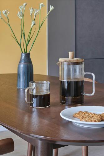 a table with a coffee pot and a plate of food at Sonder by Marriott Bonvoy Britain Quay Apartments Grand Canal Square in Dublin