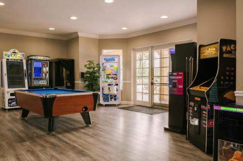 a room with several arcade games and a pool table at Sonder by Marriott Bonvoy Vista Cay Apartments in Orlando