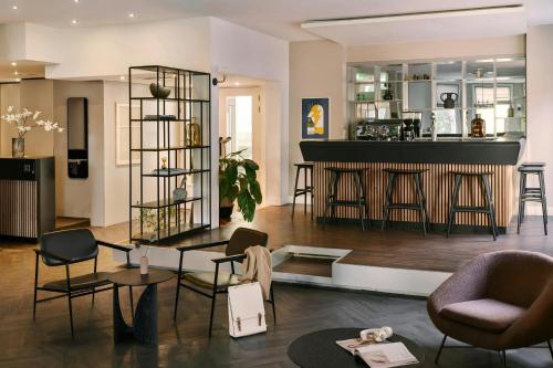 a room with a bar with chairs and a counter at Park House Hotel Museum Quarter, Sonder by Marriott Bonvoy in Amsterdam