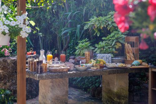 a table with food and drinks on it at Hôtel La Villa Sainte Valérie Adults Only in Juan-les-Pins