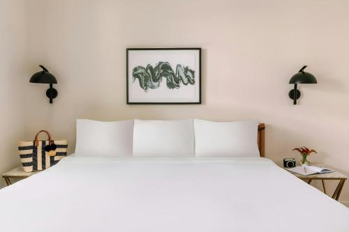 a bedroom with a large white bed and two lamps at Sonder by Marriott Bonvoy Vista Cay Apartments in Orlando