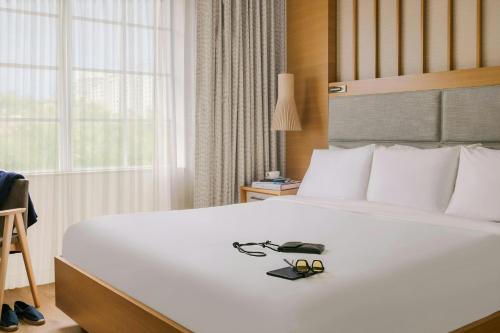 a bedroom with a bed with a pair of glasses on it at The Abbey Hotel Miami Beach, Sonder by Marriott Bonvoy in Miami Beach