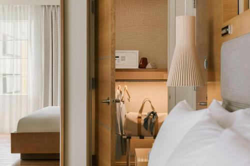 a bedroom with a bed and a desk and a lamp at The Abbey Hotel Miami Beach, Sonder by Marriott Bonvoy in Miami Beach
