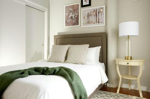a bedroom with a bed with a green blanket on it at Sonder by Marriott Bonvoy The Broughton Apartments Historic District in Savannah