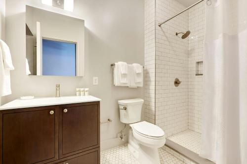 a bathroom with a toilet and a sink and a shower at Sonder by Marriott Bonvoy The Broughton Apartments Historic District in Savannah