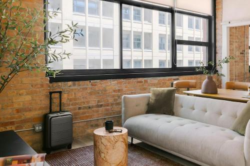 a living room with a couch and a large window at Sonder by Marriott Bonvoy The Burnham Apartments Loop in Chicago