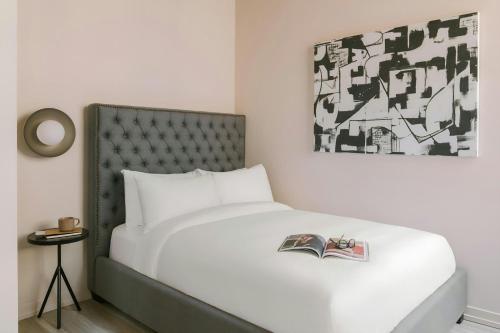 a bedroom with a bed with a book on it at Sonder by Marriott Bonvoy The Burnham Apartments Loop in Chicago