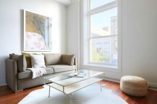 a living room with a couch and a glass coffee table at Sonder by Marriott Bonvoy The Broughton Apartments Historic District in Savannah
