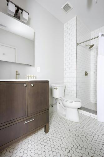a bathroom with a toilet and a sink and a shower at Sonder by Marriott Bonvoy The Broughton Apartments Historic District in Savannah