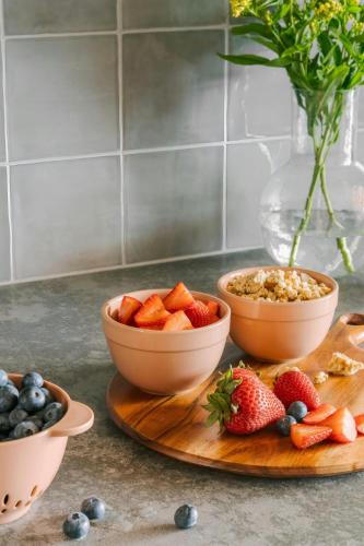 a table with bowls of fruit on a cutting board at Sonder by Marriott Bonvoy The Burnham Apartments Loop in Chicago