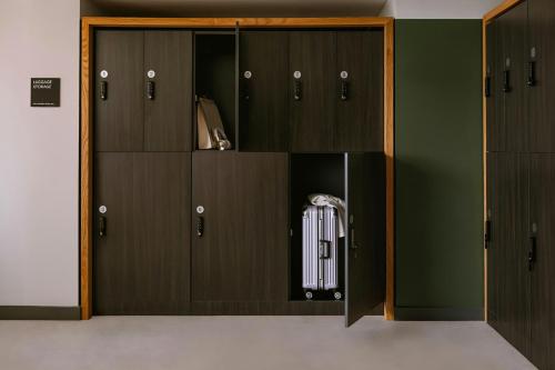 a locker room with black doors and auggage at Sonder by Marriott Bonvoy The Burnham Apartments Loop in Chicago