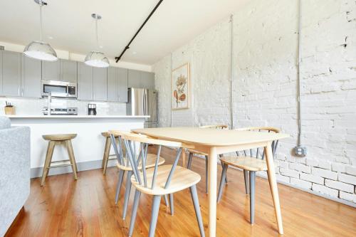 a kitchen and dining room with a wooden table and chairs at Sonder by Marriott Bonvoy The Broughton Apartments Historic District in Savannah