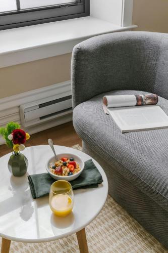 a coffee table with a bowl of food on a couch at Sonder by Marriott Bonvoy Jewelers Row Apartments Millenium Park in Chicago