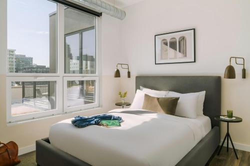 a bedroom with a large white bed with a window at Sonder by Marriott Bonvoy The Opal Apartments River North in Chicago