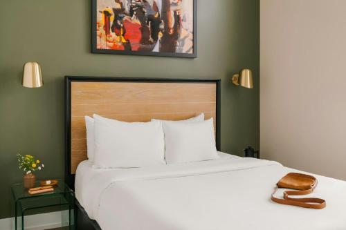 a bedroom with a large white bed with a wooden headboard at Sonder by Marriott Bonvoy Jewelers Row Apartments Millenium Park in Chicago