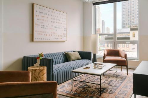 a living room with a couch and chairs and a table at Sonder by Marriott Bonvoy The Opal Apartments River North in Chicago