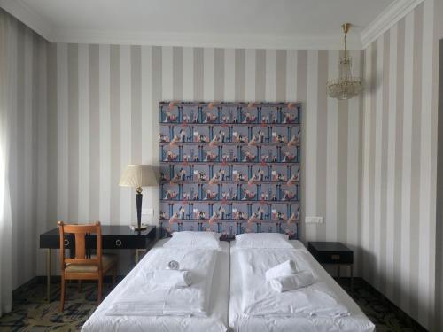 a bedroom with two beds and a wall with penguins at Pannonia 1893 Prémium in Sopron