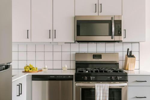 a kitchen with a stove and a microwave at Sonder by Marriott Bonvoy The Opal Apartments River North in Chicago